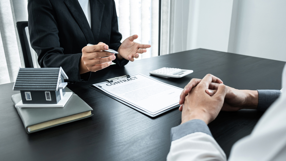 Estate agent broker presentating to client decision signing agreement contract real estate with approved mortgage application, buying mortgage loan offer for and house insurance.