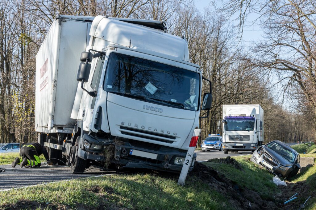 Truck accident. At the rear, a passenger car destroyed in an accident in a ditch