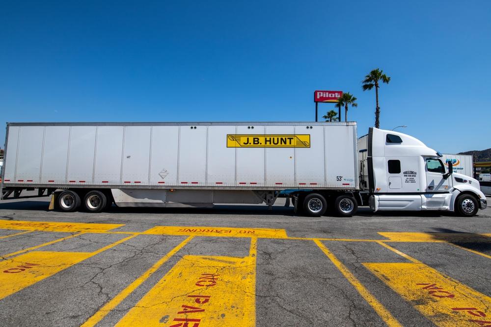 Big rig, semi trucks transporting products on trailers. J.B. Hunt trucking company. tariff, tariffs, global trade, trade war