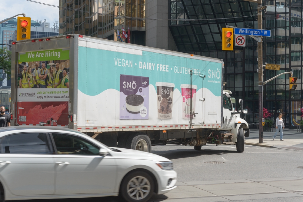 Dairy Free, a Canadian brand, transportation truck turning south on Bay St at Wellington St W