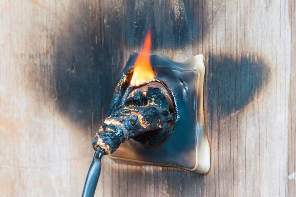 Burning electrical outlet caused by faulty wiring illustrating Product Liability in Utah for defective products sold in Midvale causing serious injuries