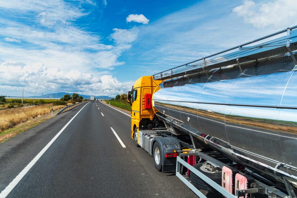 Large tanker truck driving on highway, illustrating serious Midvale truck accident cases where insurers try to settle before the full extent of injuries is known.