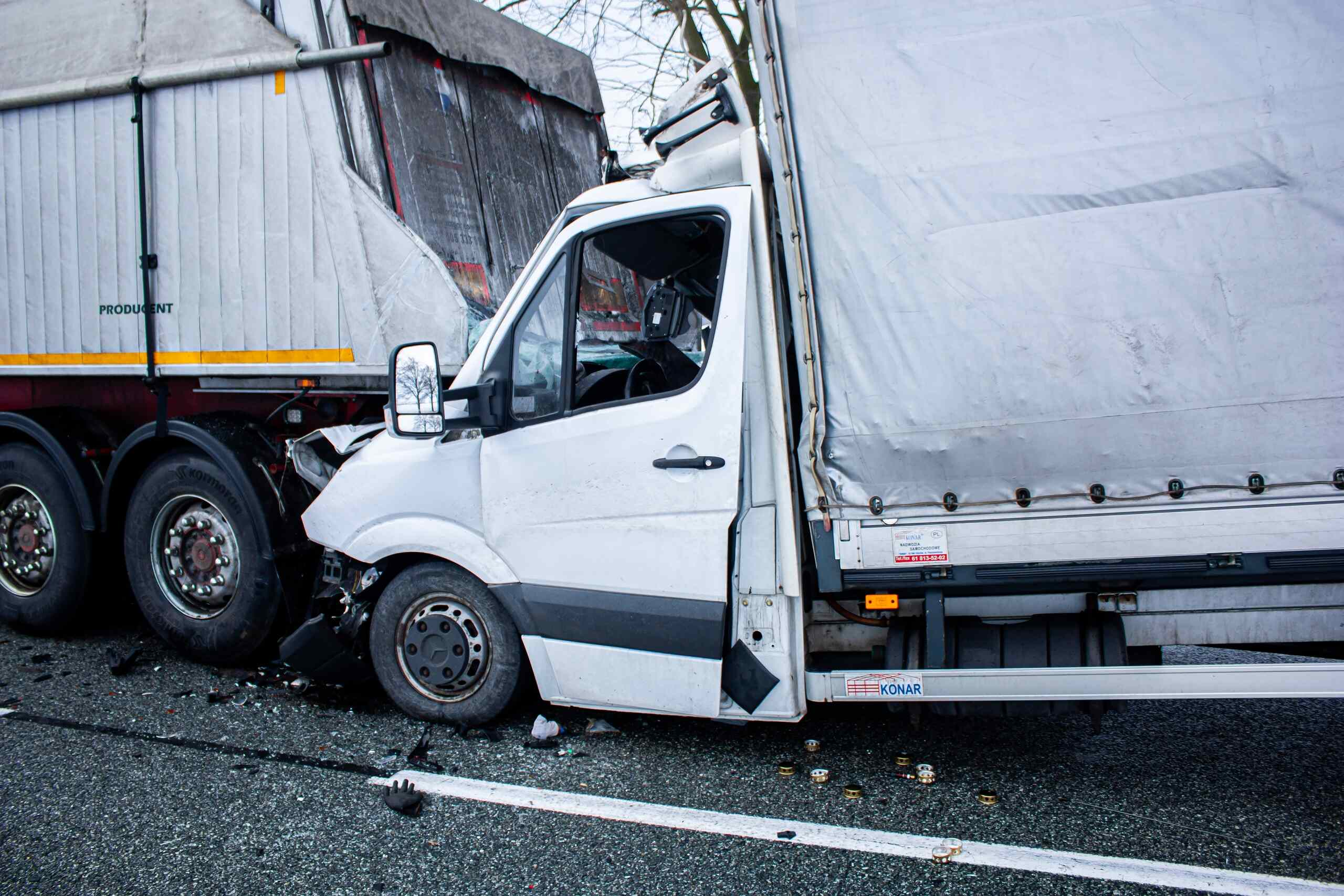 Commercial truck crashed off roadway with damaged passenger vehicle nearby, illustrating increased accident risk amid the Midvale trucking boom and rising commercial traffic.