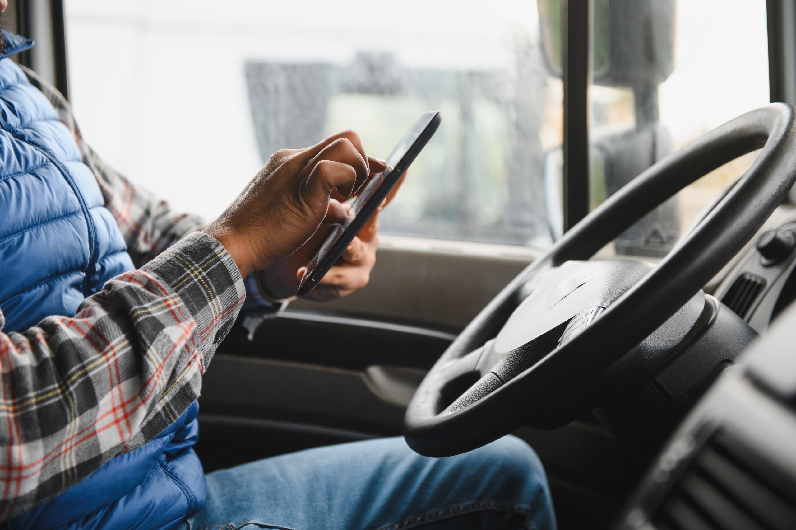 Distracted truck driver using a mobile device near Ogden Rail Yard.