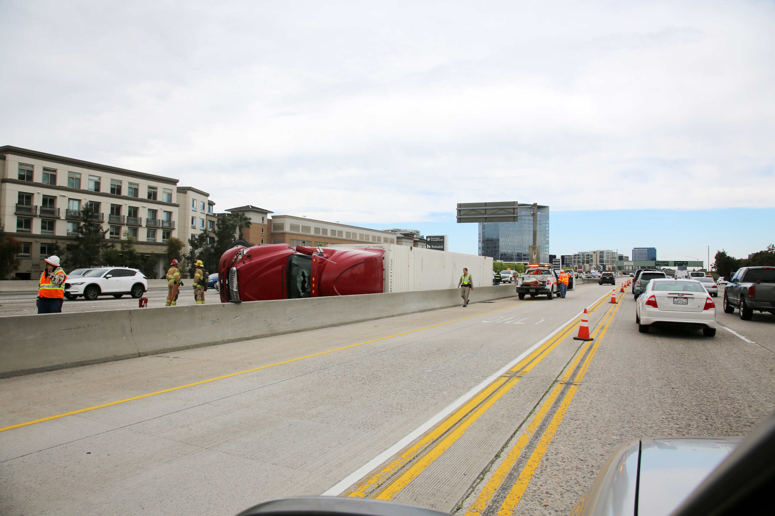 Overturned semi-truck blocking highway lanes in Utah, illustrating why trucking insurers deny valid claims after serious Midvale truck accidents.