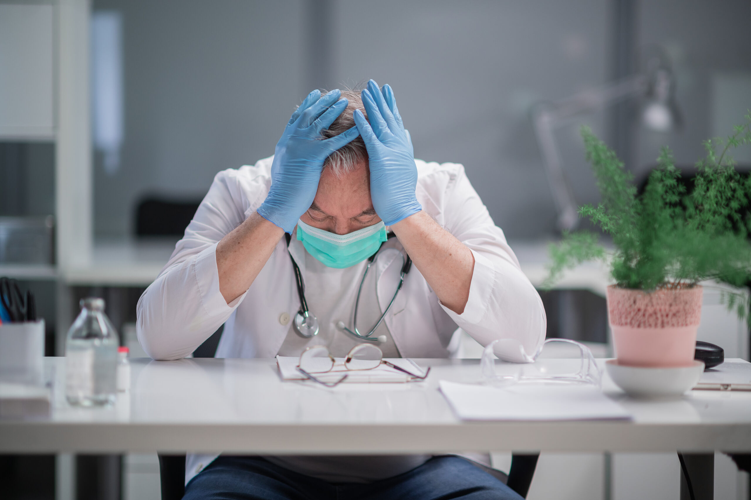 A healthcare provider in Midvale overwhelmed by the emotional toll of a loss, representing the profound grief and suffering addressed in a wrongful death lawsuit.
