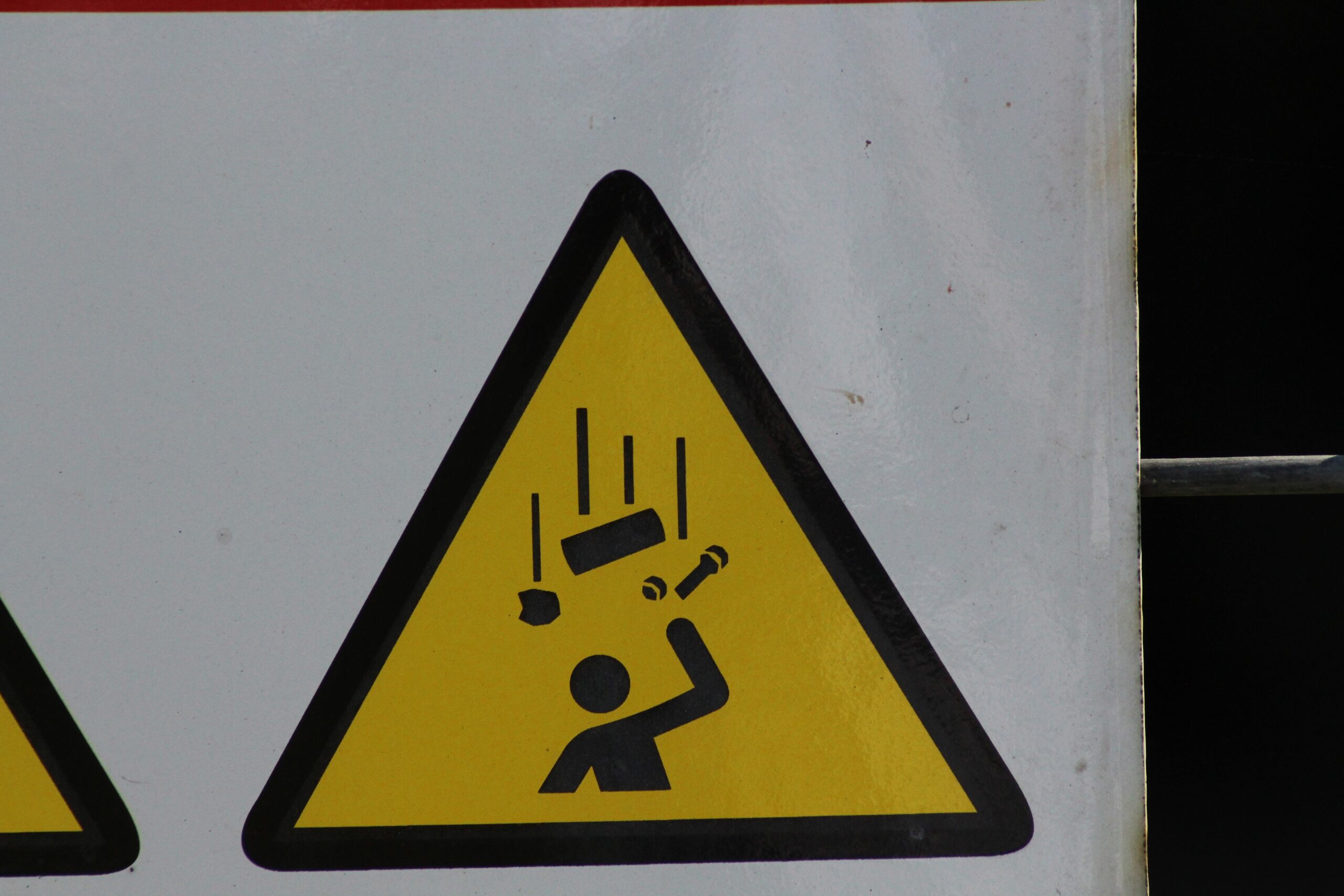 Warning sign at a Provo construction site illustrating the dangers of falling objects like tools or building materials.