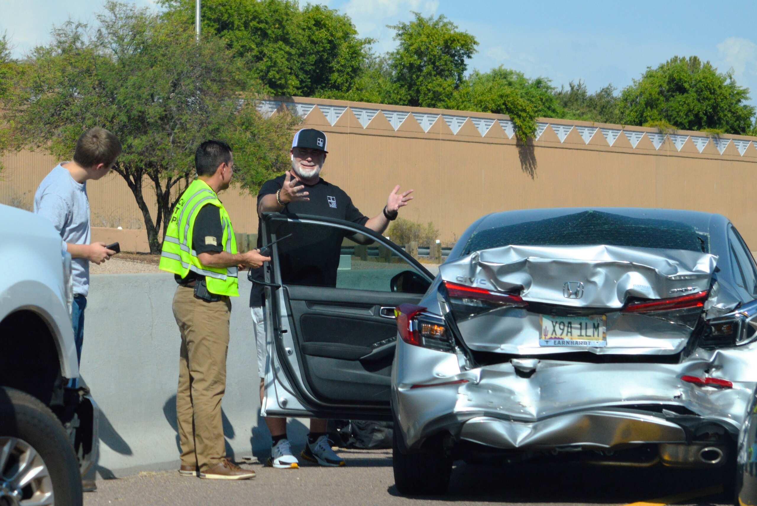 Driver discussing damages after a rear-end collision in Salt Lake City involving an out-of-state vehicle.