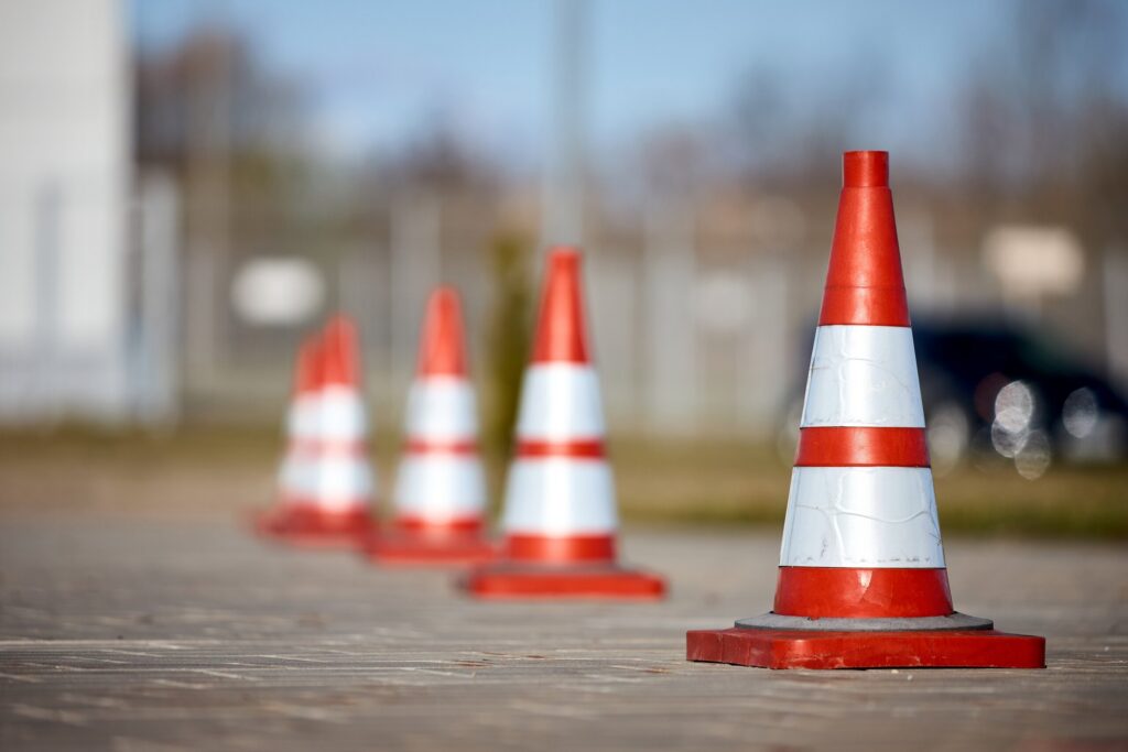 A row of safety cones marking off a scene, representing Phase One of a construction accident investigation in Salt Lake City: immediate response and scene preservation.