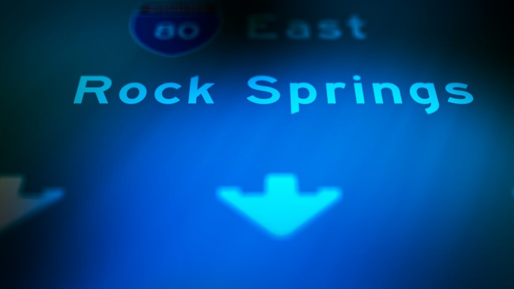 A digital highway sign displaying Rock Springs indicates the service location for Rock Springs Rideshare Accident Lawyers.