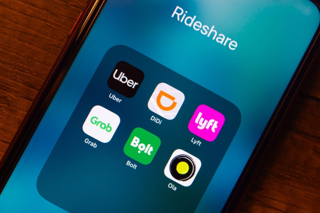 A smartphone screen displaying rideshare apps like Uber and Lyft relates to claims handled by Rock Springs Rideshare Accident Lawyers.